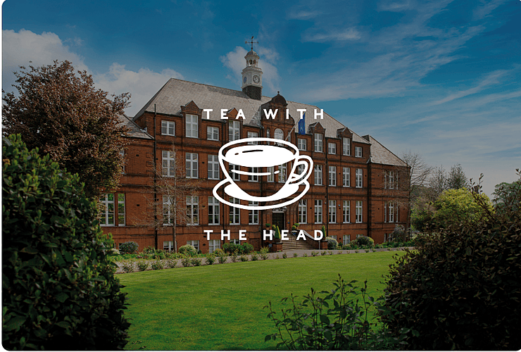 A red-brick school building with a clock tower and neatly trimmed lawn, featuring the text “Tea with the Head” and a white teacup graphic overlay.