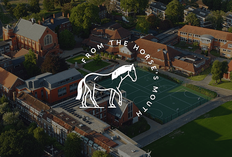 Aerial view of a school campus with red-brick buildings, a sports court, and the text “From the Horse’s Mouth” with a white horse graphic overlay.