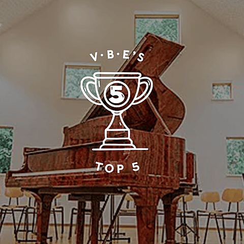A grand piano in a bright music room with chairs and windows, overlaid with a graphic reading “VBE’s Top 5.”