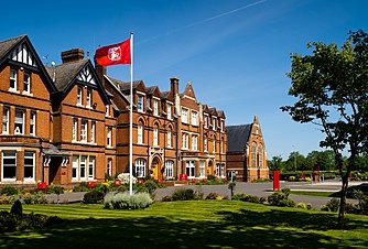 Kent College's red bricked main school building from the front