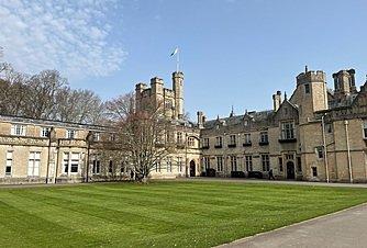 Historic boarding school building with large lawn and classic architecture