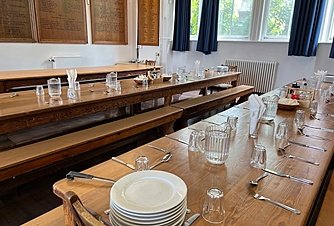 Long set dining tables for the in house dining at the boarding houses