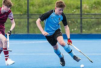 two boys in action on the hockey pitch