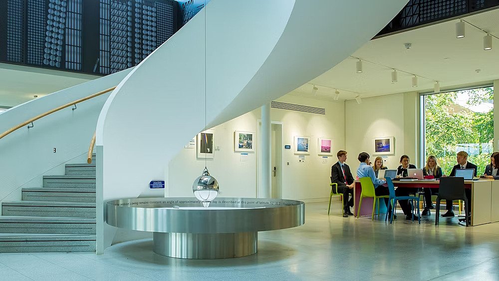 A modern white staircase and a pendulum