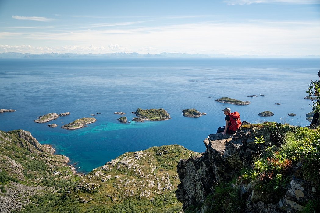 A Gordonstoun pupil sitting on a cliff overlooking a gorgeous Scottish bay