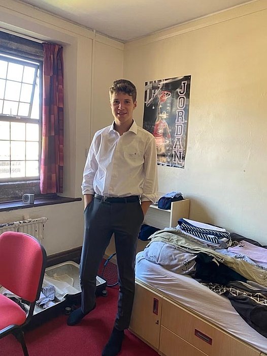 Student standing in his boarding room