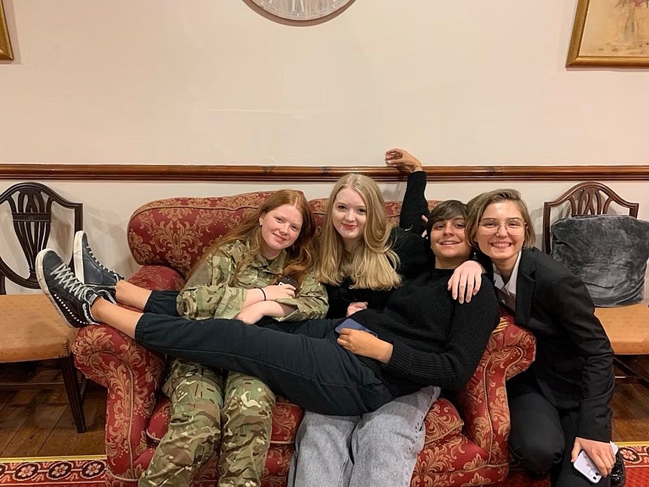 Pupil Charlotte with three friends relaxing on a boarding house sofa