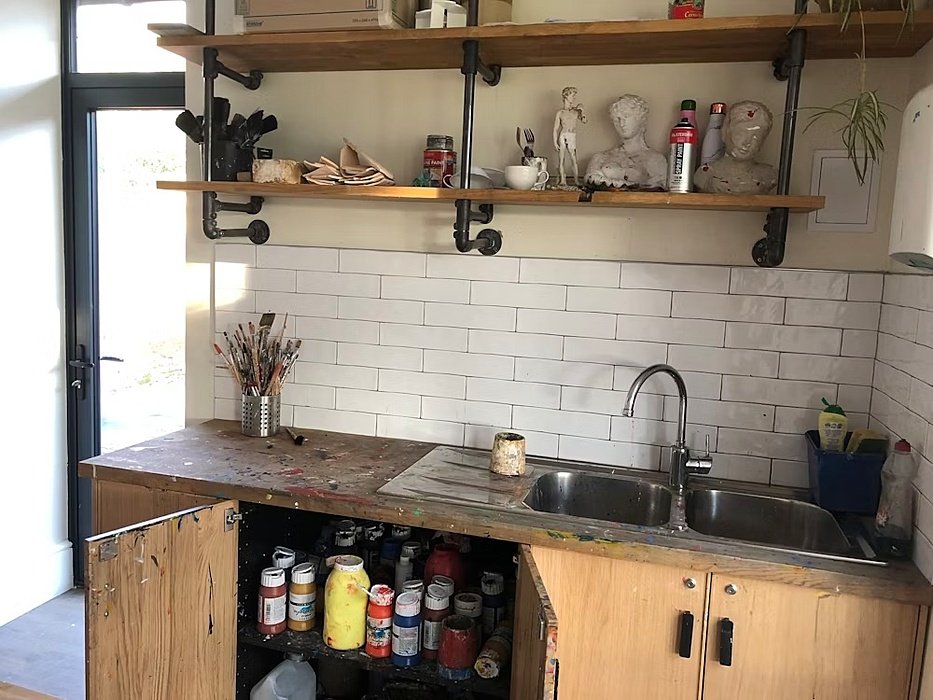 Sink and shelf with art tools and works