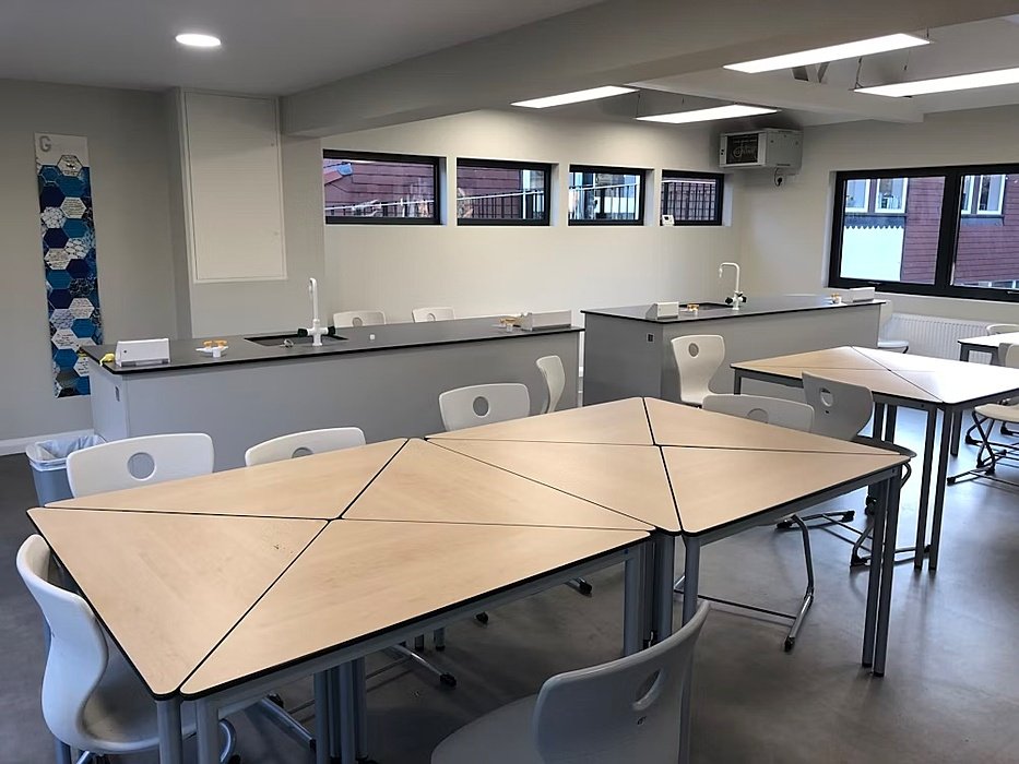 class tables with white chairs