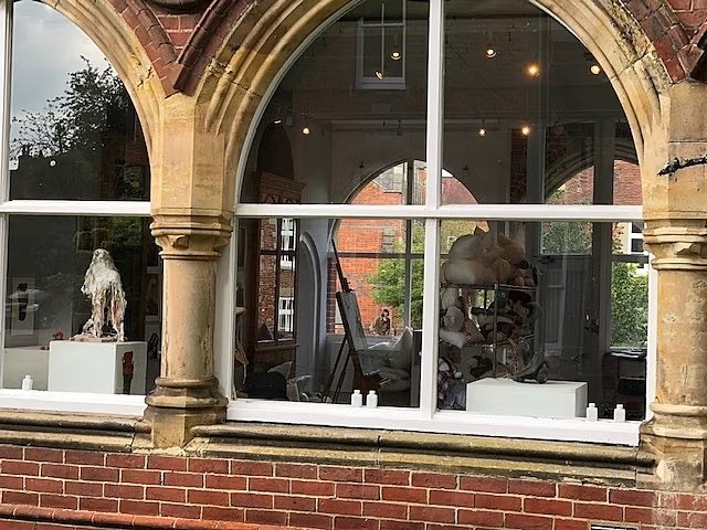 An arched window looking into an art studio