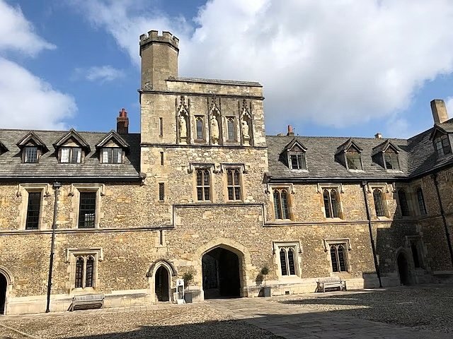 An old grey boarding house with a little tower