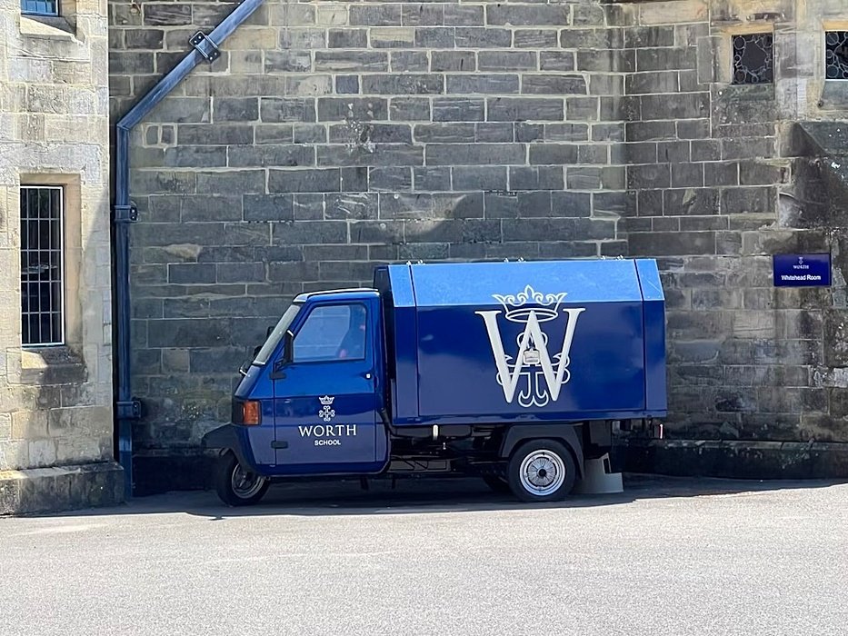 mobile cafeteria, little blue van infront of stonewall