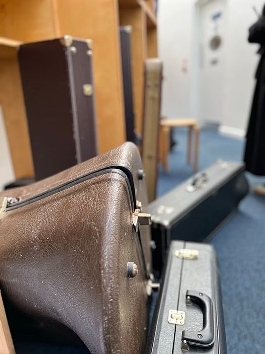 Close up of several violin cases