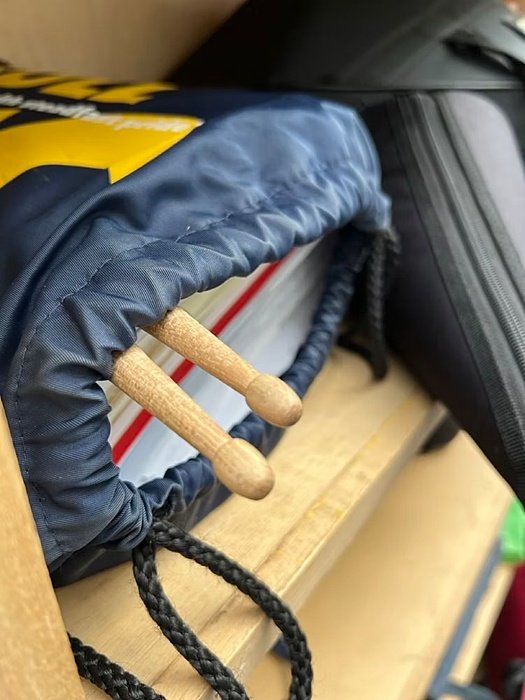 Open school bag with books and Drumsticks