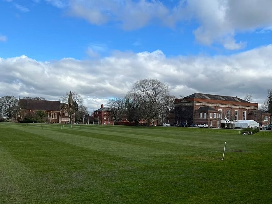 Big sportfields, some school houses in the background