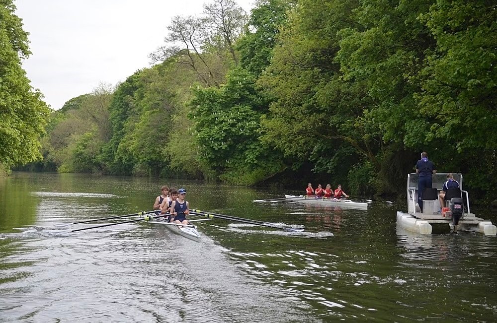 Pupils rowing on the river