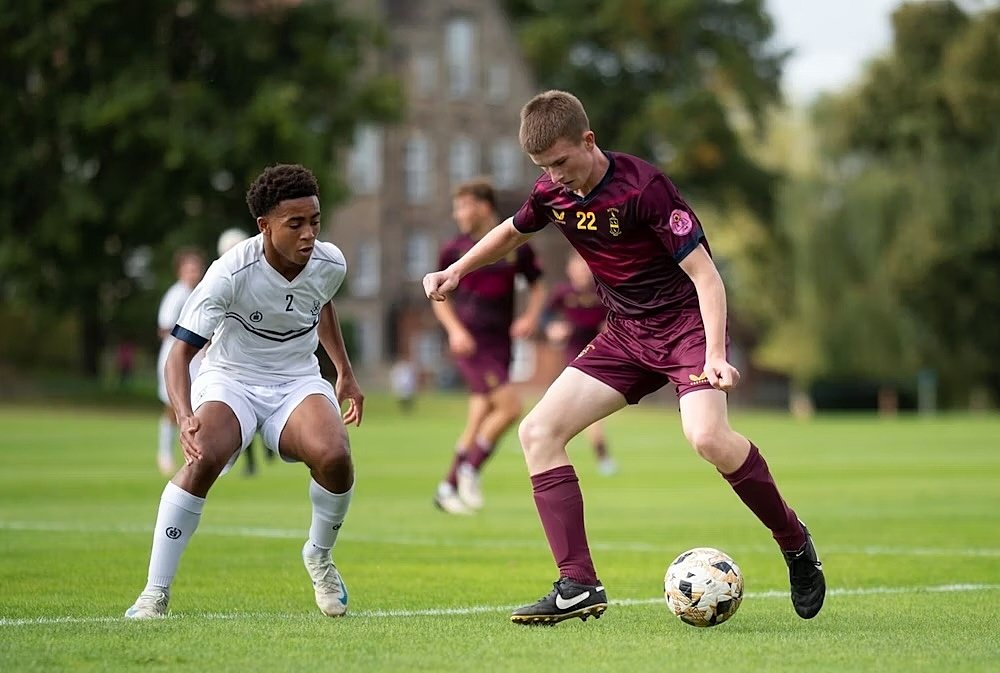 Repton's football players in action outside on the pitch, here against Winchester