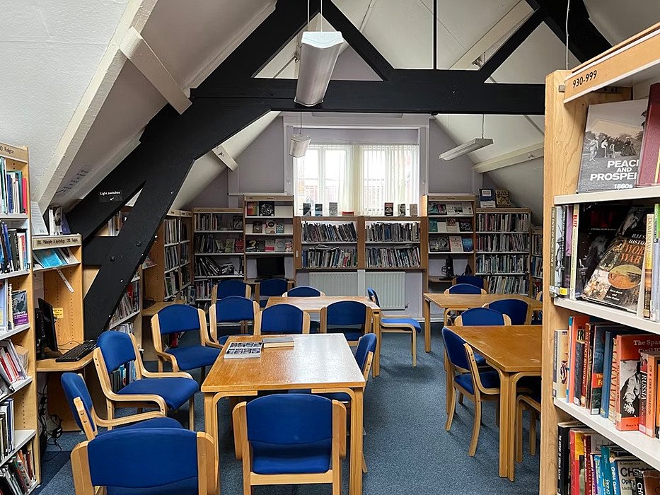 Library with blue chairs and tables