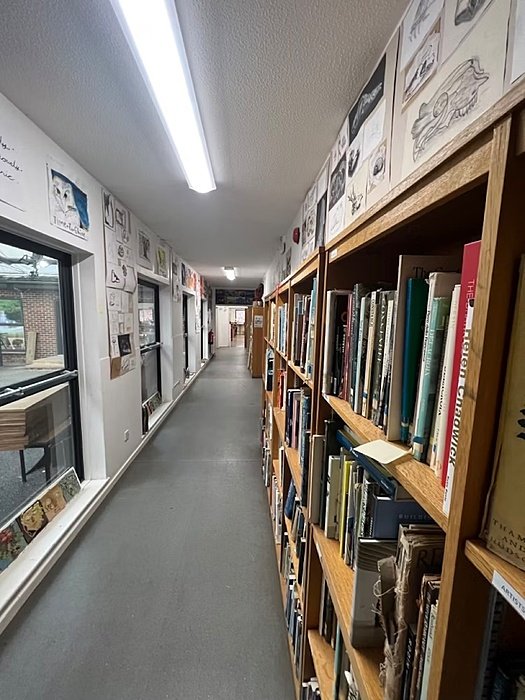 Corridor with art and bookshelves