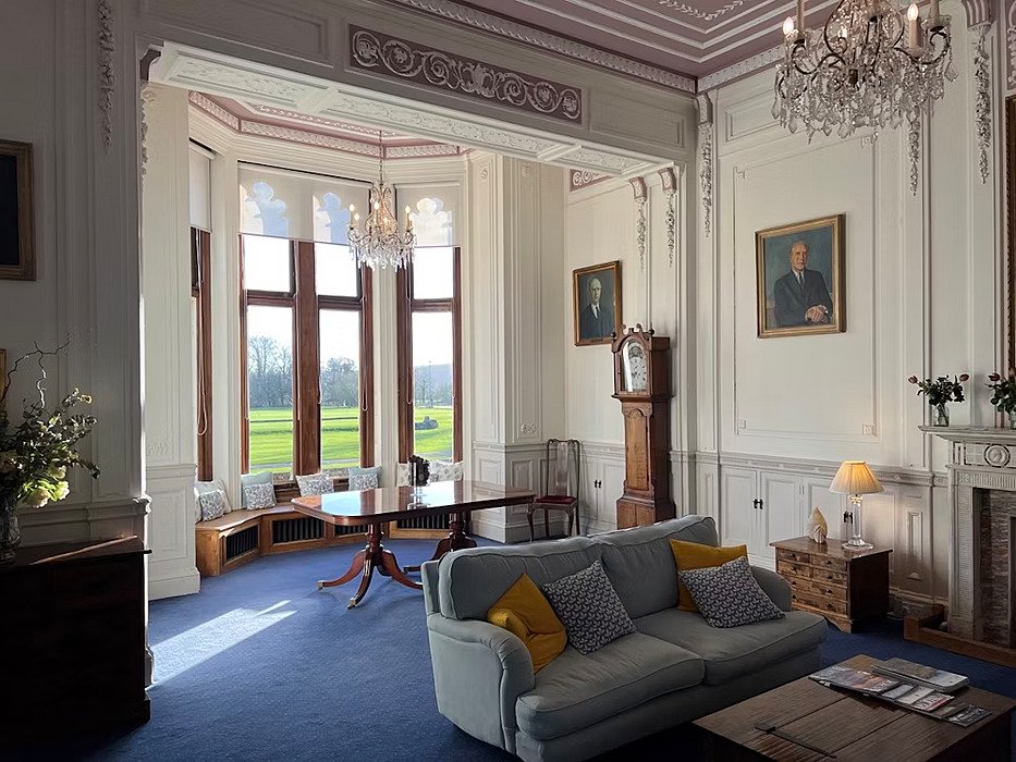 reception room in the main house with sofas and huge windows