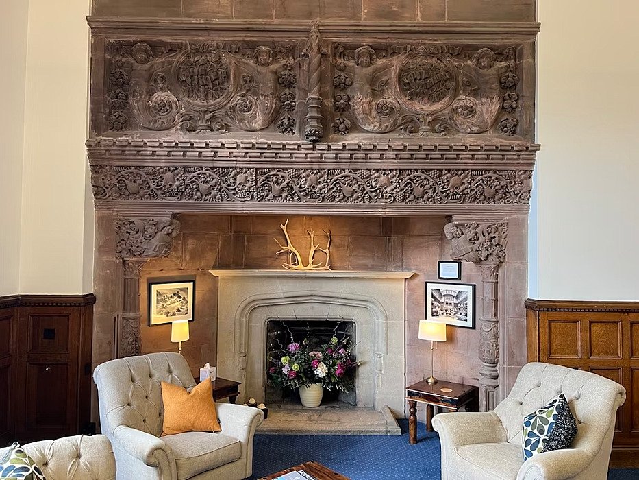 beautiful reception area with old chimnea and sofa chairs