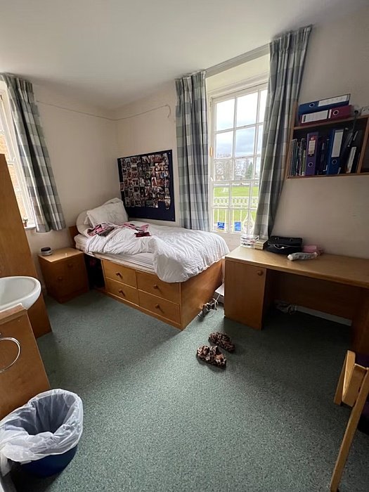 a single room with bed and table