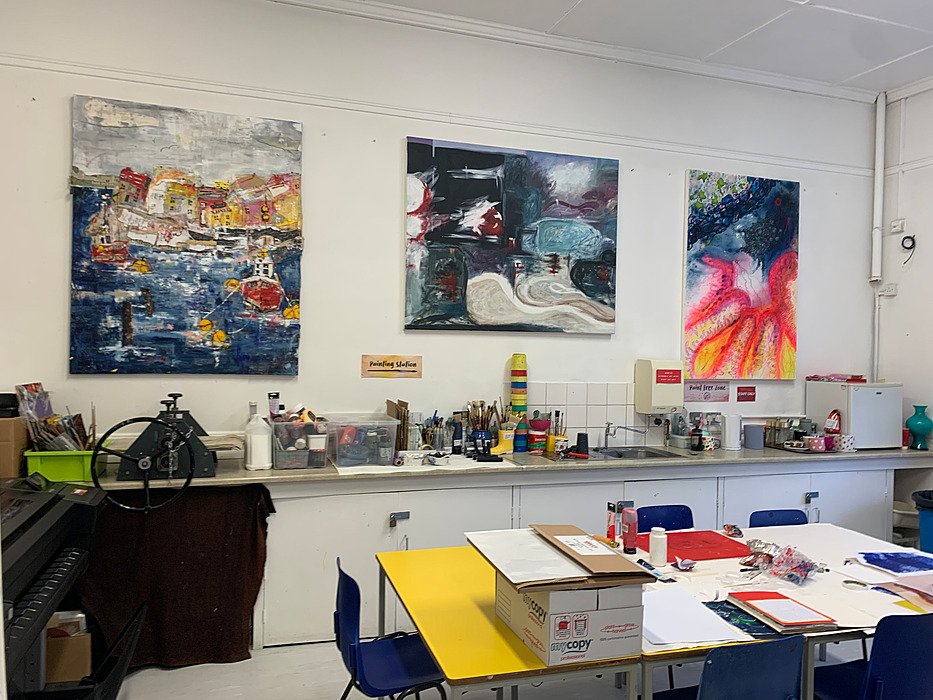Art classroom displaying student artwork and workstations