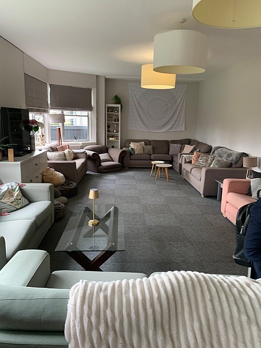Modern boarding house lounge with sofas and seating area