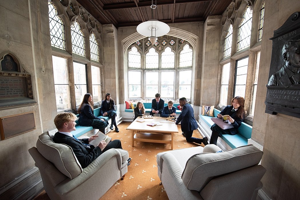 Students meeting in elegant and cosy common room with large windows