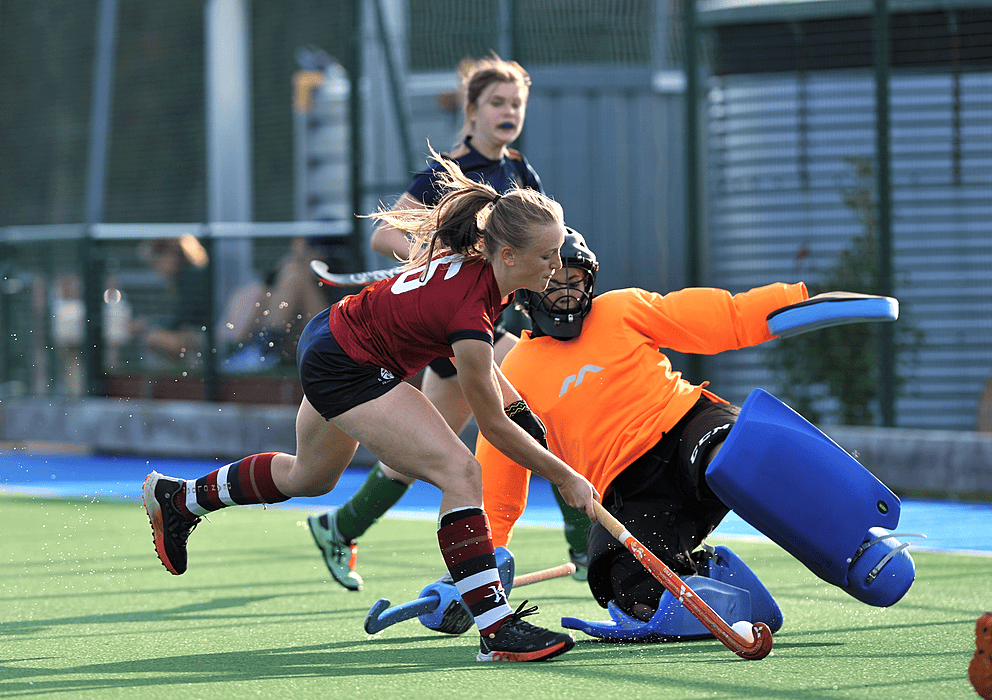 The girls Hockey team at Dean Close is playing a game in astro turf