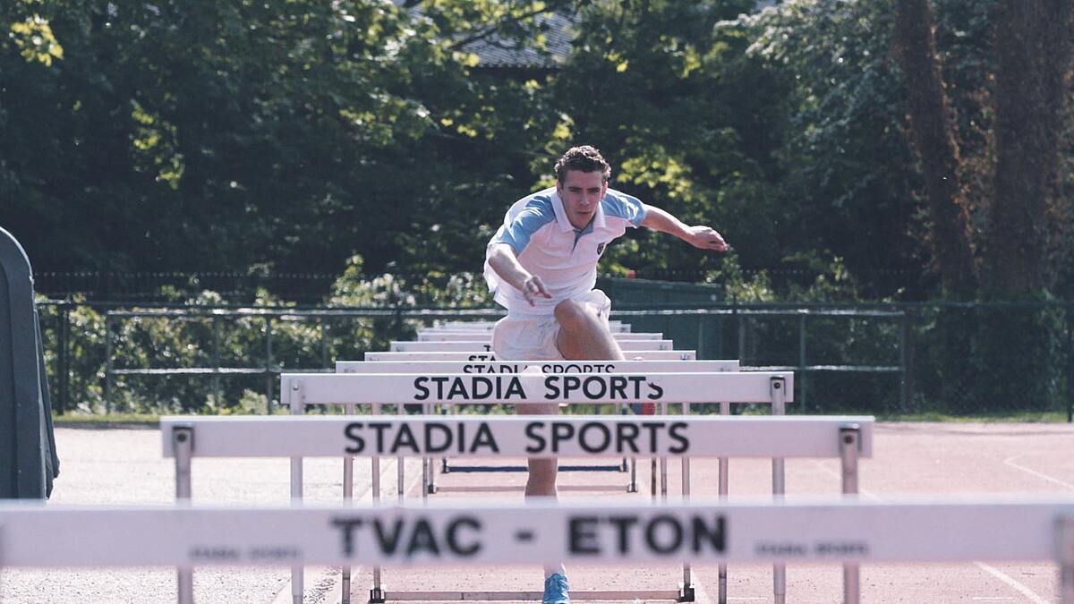 A student running the hurdles at Eton College