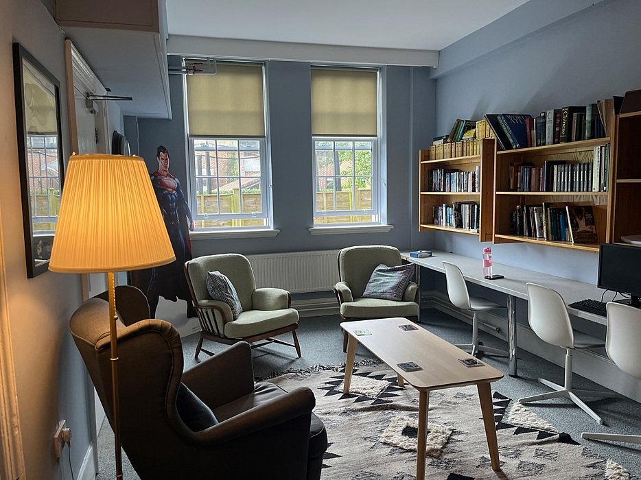 A cosy communal space with chairs and desks in one of the boarding houses