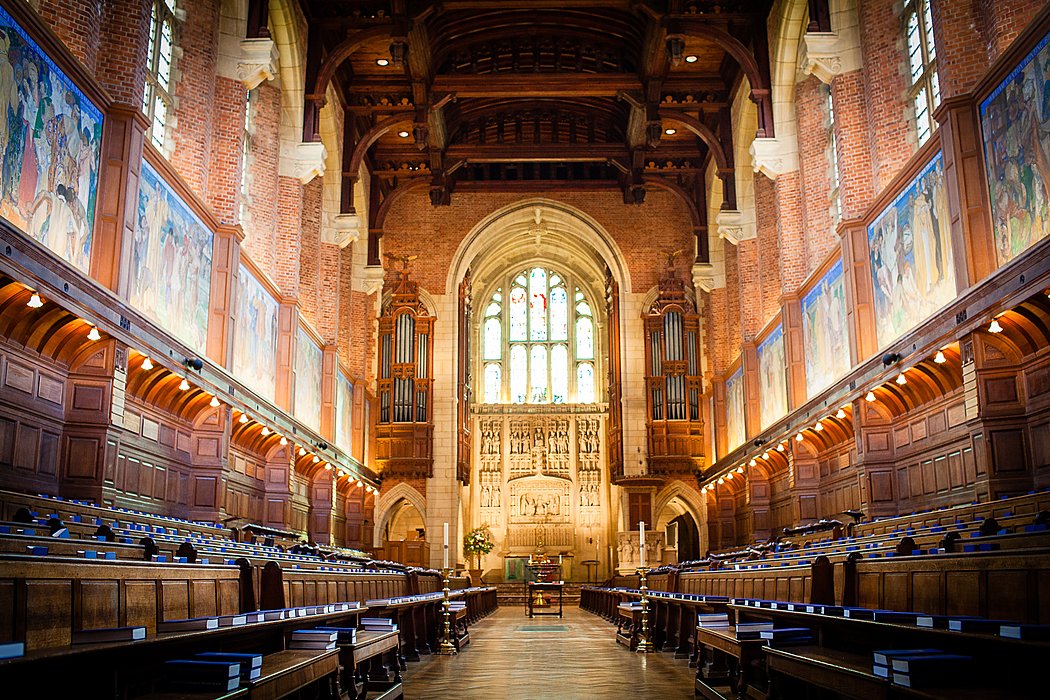 Chapel interior with wooden ceiling and stained glass windows