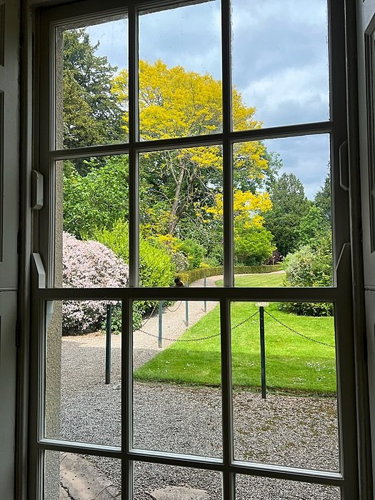 A view through a window into the beautiful garden of the school