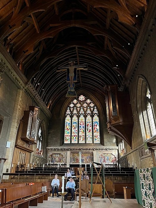a beautiful school chapel with a couple of students sitting down
