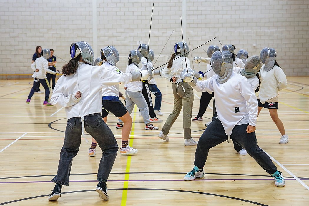 Students fencing in a sports hall during the Sedbergh International Summer School