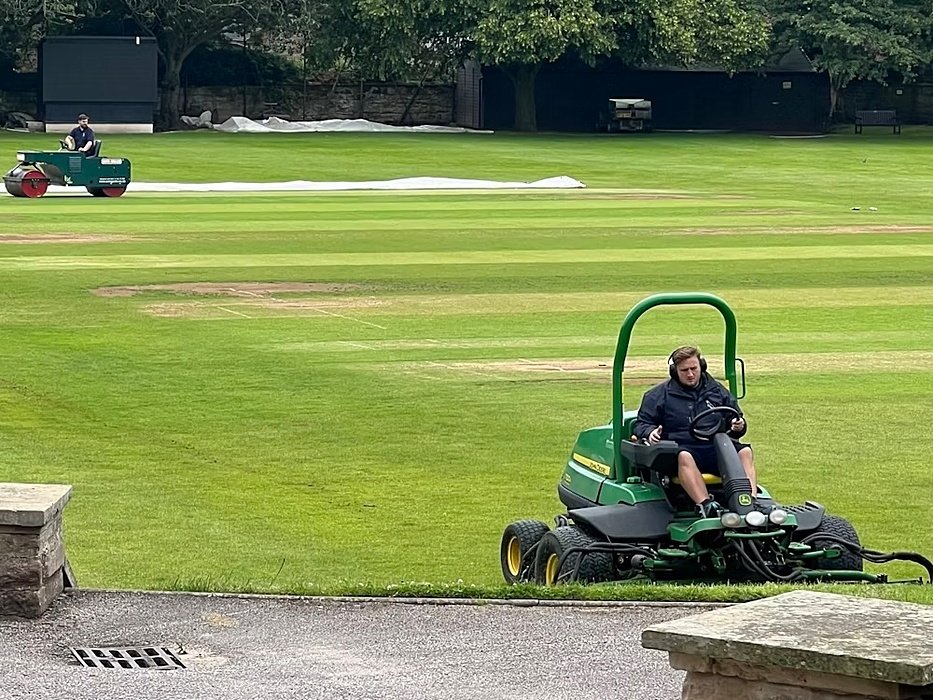 Gardeners at their work on sit on loan mowers cutting the grass