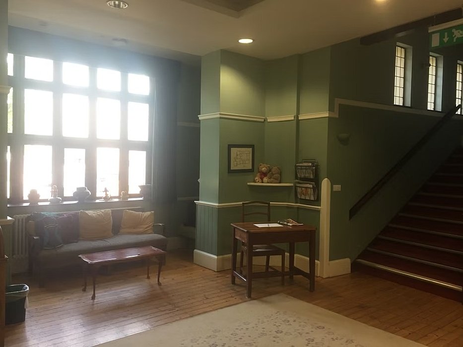 Green walls, room with a sofa and a small table