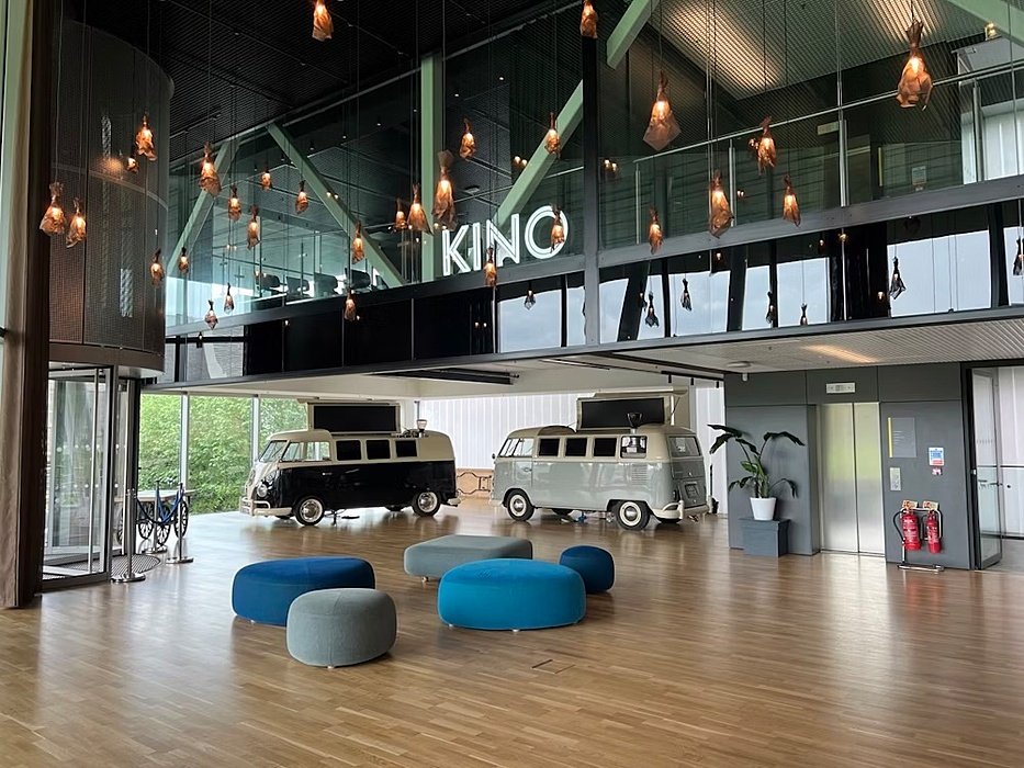 Cosy lounge area at the Cinema with old VWs inside the Sports & Science Center