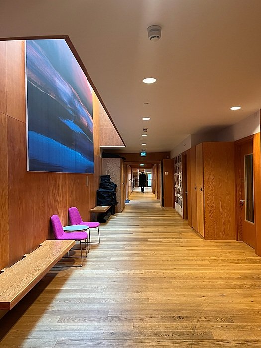 Corridor at St Edward’s Oxford with wooden panels and student art display.