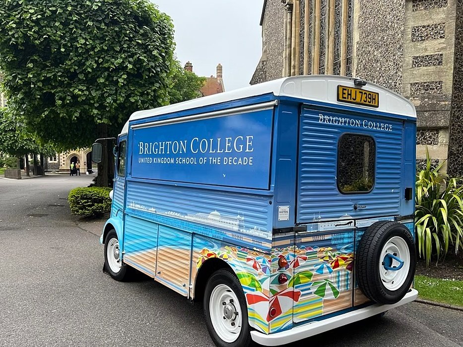 an old van with an allover painting of Brighton advertising the College