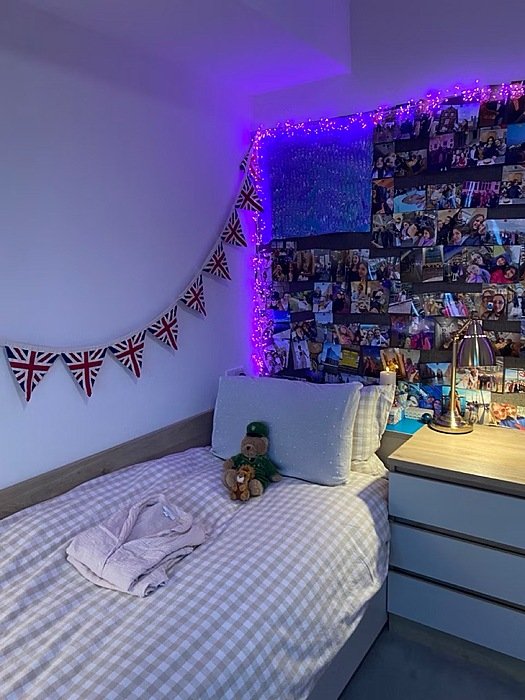 A single boarding rool with bunting and pictures on a pin wall