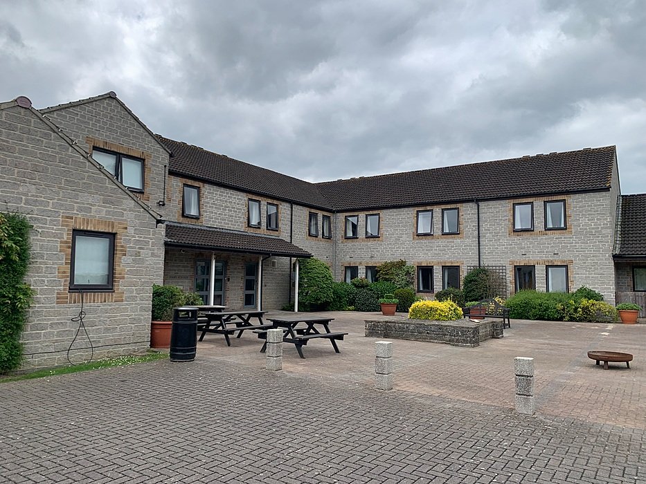 Modern boarding school building with courtyard and picnic tables