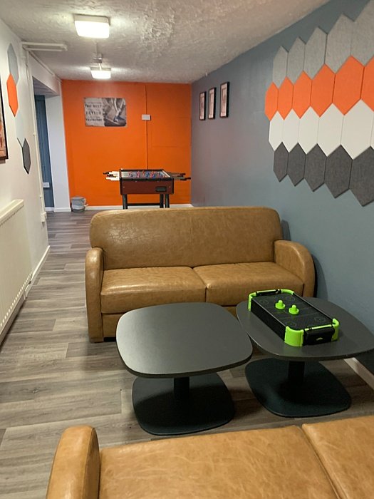 Small lounge area with sofa and game table