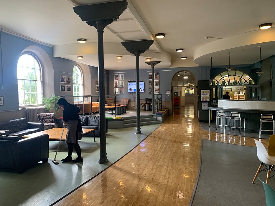 Bright cafe hall with tables, chairs , sofas and counter