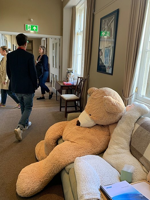 Girls Boarding house common room with large teddy bear.