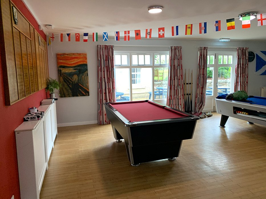 Boarding house games room with pool table for students.
