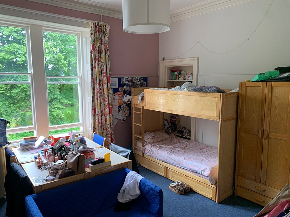 Cosy boarding room with bunk bed, study desk and natural light.