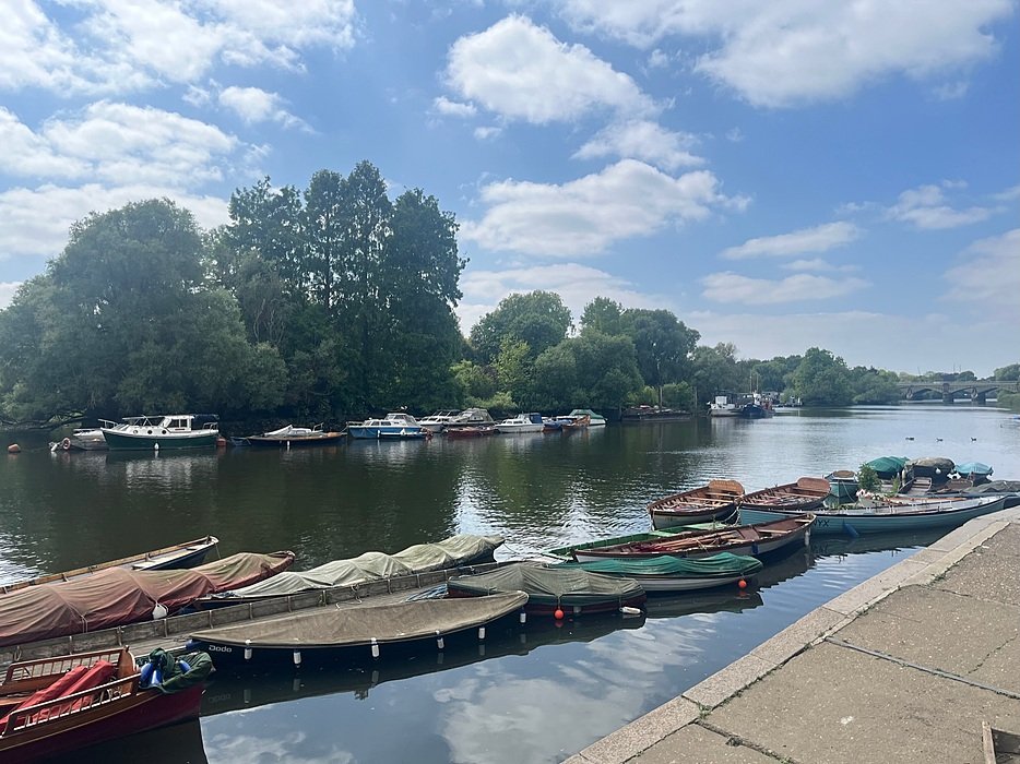 belayed boats on the water lined up along the river Thames