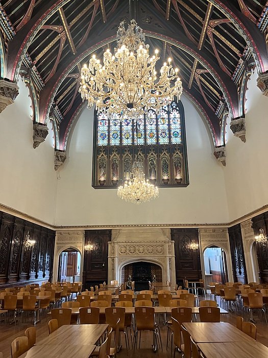 Dining hall with chandelier and tables and chairs